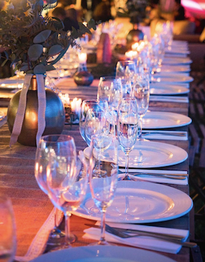 long banquet table with plants and glassware